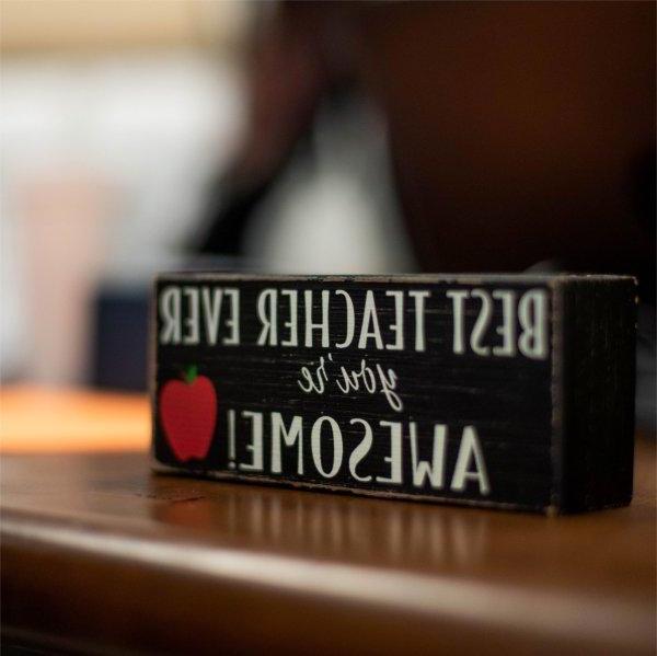 Closeup of sign on teacher's desk that reads "Best Teacher Ever. You're Awesome!"