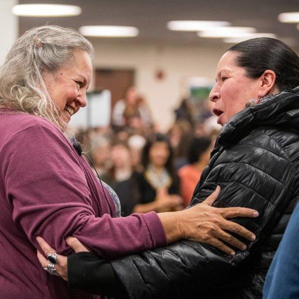 Shannon Martin, left, greets author Robin Wall Kimmerer